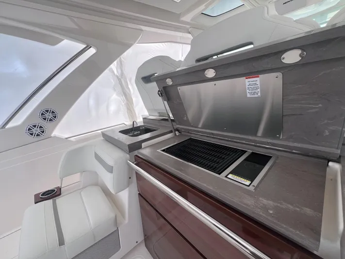  Yacht Photos Pics 2023 Tiara Yachts 38 LS interior with sleek kitchen and seating area.