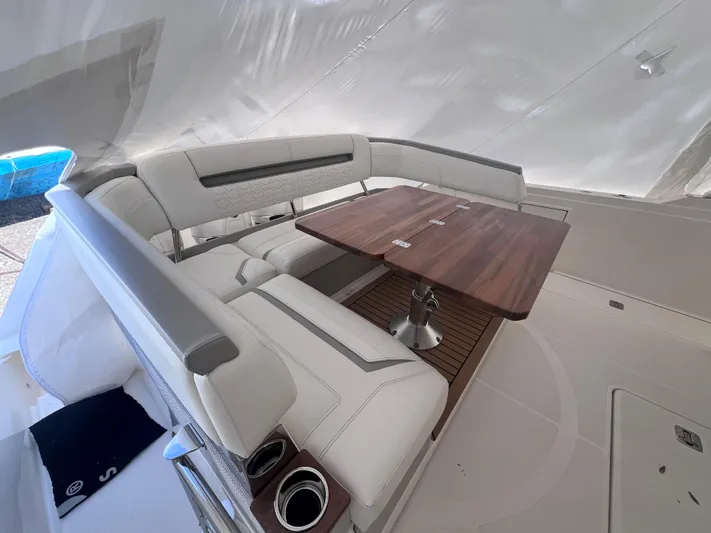  Yacht Photos Pics 2023 Tiara Yachts 38 LS interior with elegant seating and wooden table.
