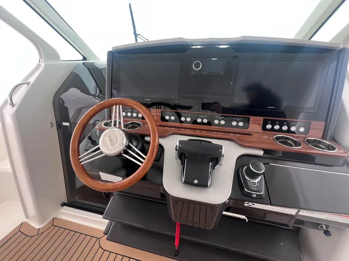  Yacht Photos Pics 2023 Tiara Yachts 38 LS helm with modern controls and wooden steering wheel.