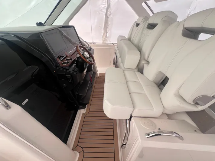  Yacht Photos Pics 2023 Tiara Yachts 38 LS interior with white seating and modern dashboard.