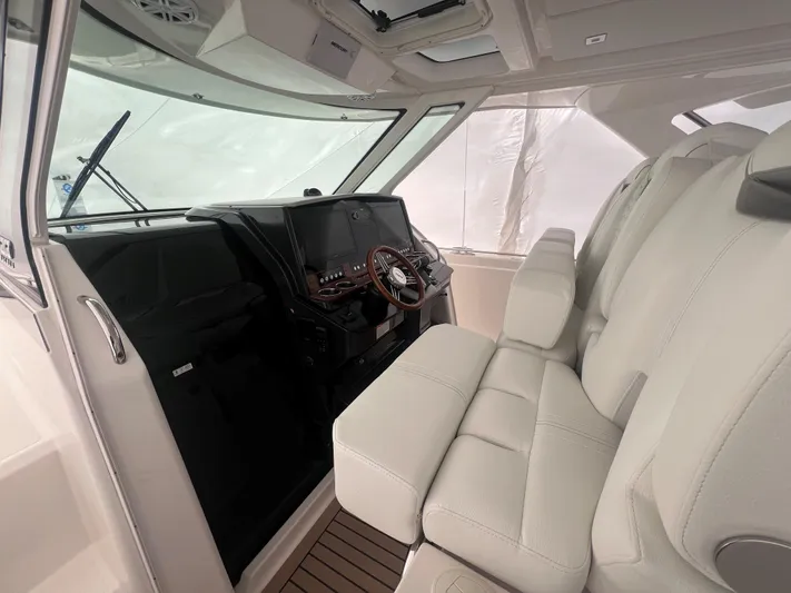  Yacht Photos Pics 2023 Tiara Yachts 38 LS interior with modern helm and plush seating.