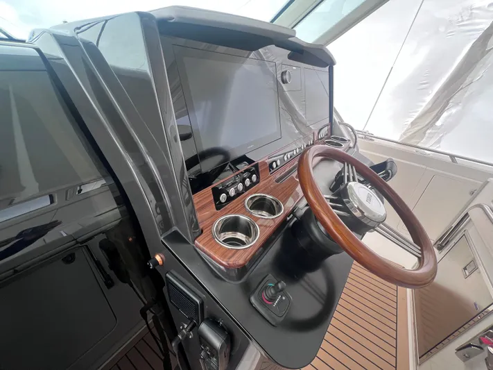  Yacht Photos Pics 2023 Tiara Yachts 38 LS helm with modern controls and wooden steering wheel.