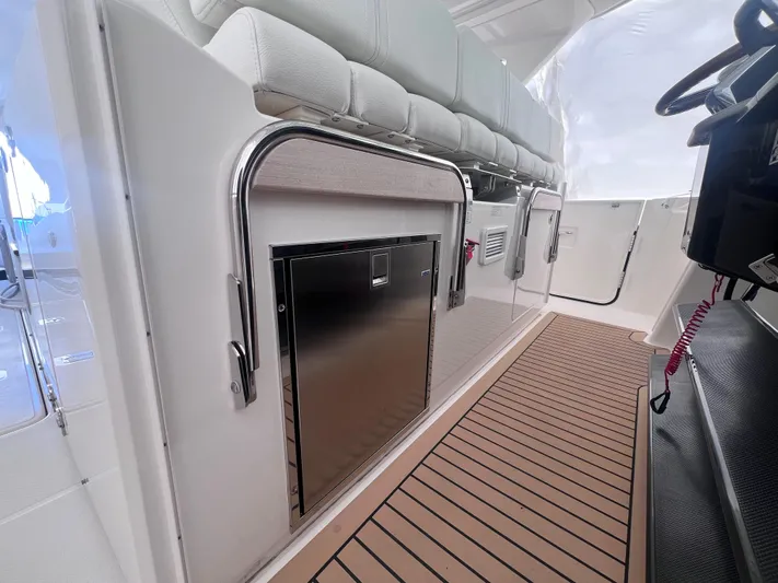  Yacht Photos Pics 2023 Tiara Yachts 38 LS interior with sleek seating and stainless steel accents.