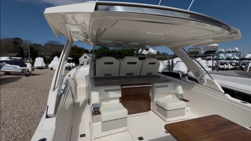  Yacht Photos Pics 2023 Tiara Yachts 38 LS interior with seating and table, showcasing luxury design.