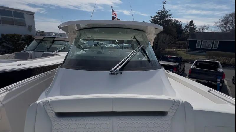  Yacht Photos Pics 2023 Tiara Yachts 38 LS boat, front view with windshield and wipers, docked outdoors.