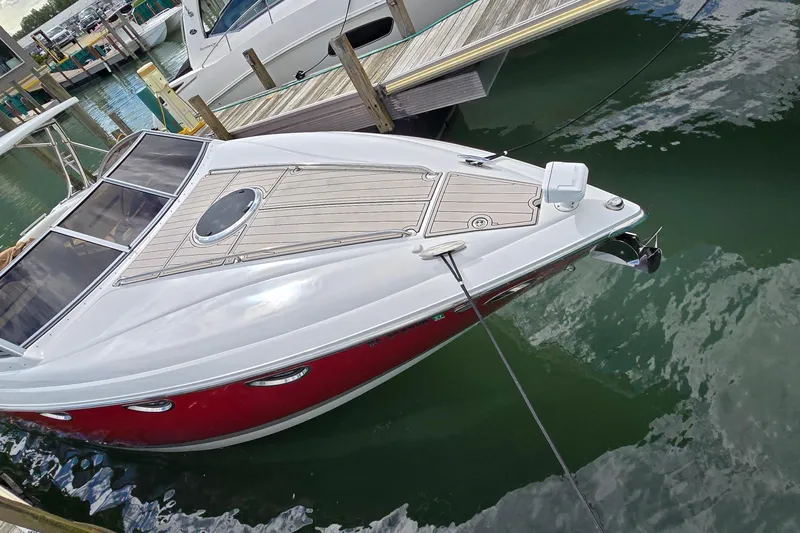  Yacht Photos Pics 2011 Cobalt 323 boat docked in marina, featuring sleek design and red hull.