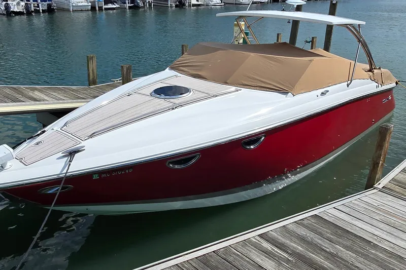  Yacht Photos Pics 2011 Cobalt 323 boat docked, featuring a red hull and tan cover.