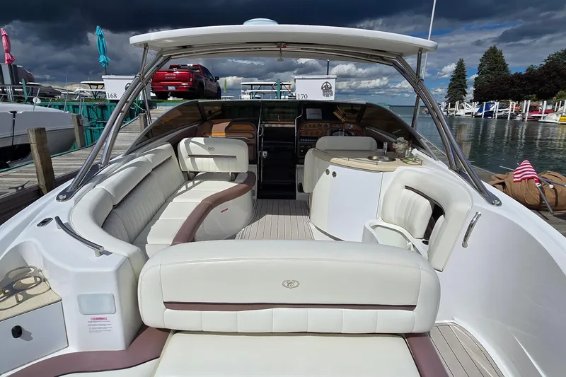 Yacht Photos Pics Luxurious 2011 Cobalt 323 boat with spacious seating, docked by a scenic marina.