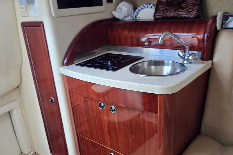  Yacht Photos Pics Compact kitchenette in 2011 Cobalt 323 boat with sink and stove.
