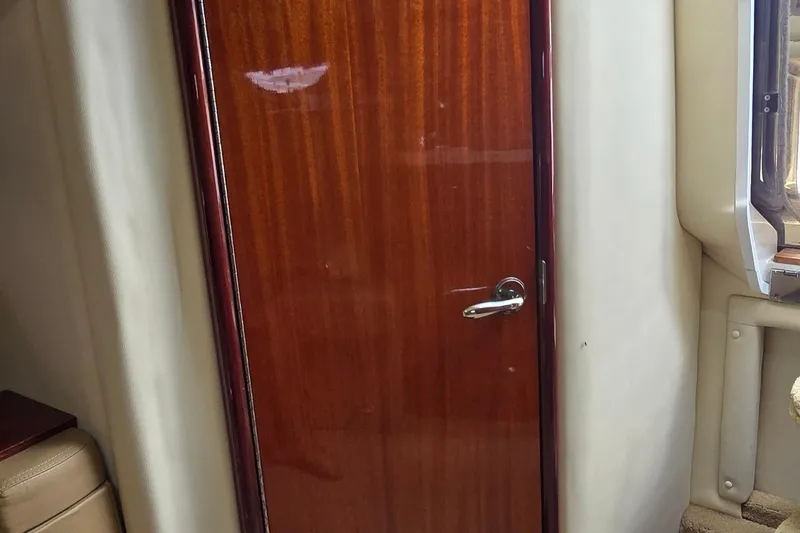  Yacht Photos Pics Wooden cabin door inside 2011 Cobalt 323 boat, featuring sleek handle and polished finish.