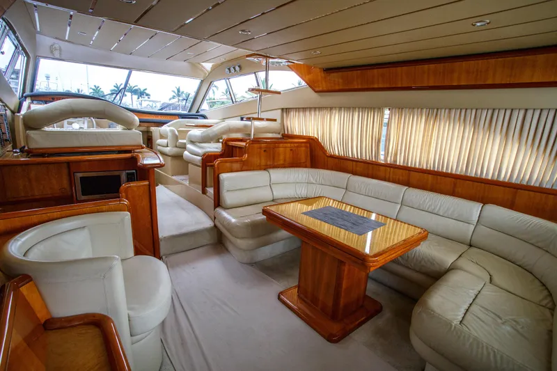 Arion Yacht Photos Pics Luxurious interior of a 2003 Ferretti Yachts 530 with plush seating and wooden accents.