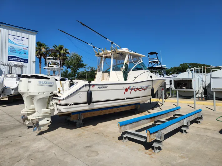 N' Pursuit Yacht Photos Pics 2005 Pursuit 3070 Offshore Center Console boat with Suzuki engines on a trailer.