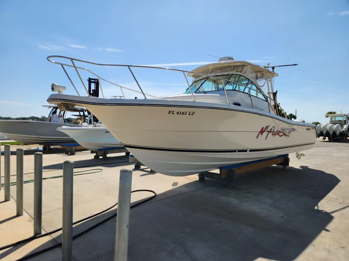 N' Pursuit Yacht Photos Pics 2005 Pursuit 3070 Offshore Center Console boat on dry dock, sunny day.