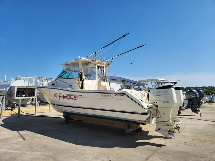 N' Pursuit Yacht Photos Pics 2005 Pursuit 3070 Offshore Center Console boat on dry dock with dual Suzuki engines.