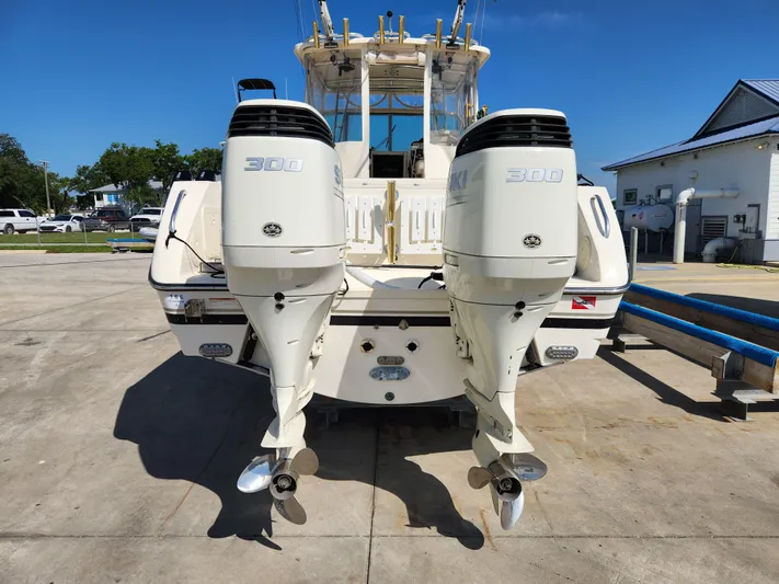 N' Pursuit Yacht Photos Pics 2005 Pursuit 3070 Offshore Center Console with twin outboard engines, parked on concrete.