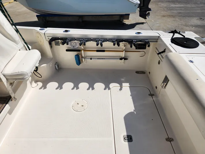 N' Pursuit Yacht Photos Pics 2005 Pursuit 3070 Offshore Center Console boat deck with rod holders and seating.