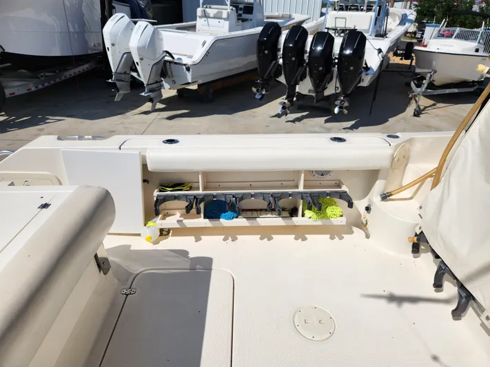 N' Pursuit Yacht Photos Pics 2005 Pursuit 3070 Offshore Center Console boat with open storage compartment and multiple outboard engines.