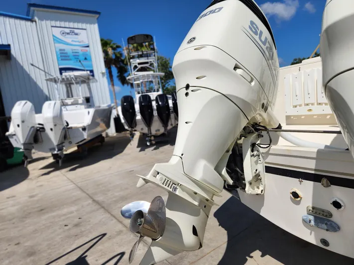 N' Pursuit Yacht Photos Pics 2005 Pursuit 3070 Offshore Center Console with Suzuki outboard motor in a boatyard.