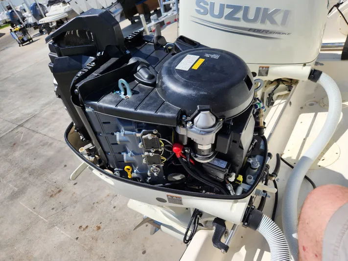 N' Pursuit Yacht Photos Pics 2005 Pursuit 3070 Offshore Center Console with Suzuki outboard engine, open for maintenance.