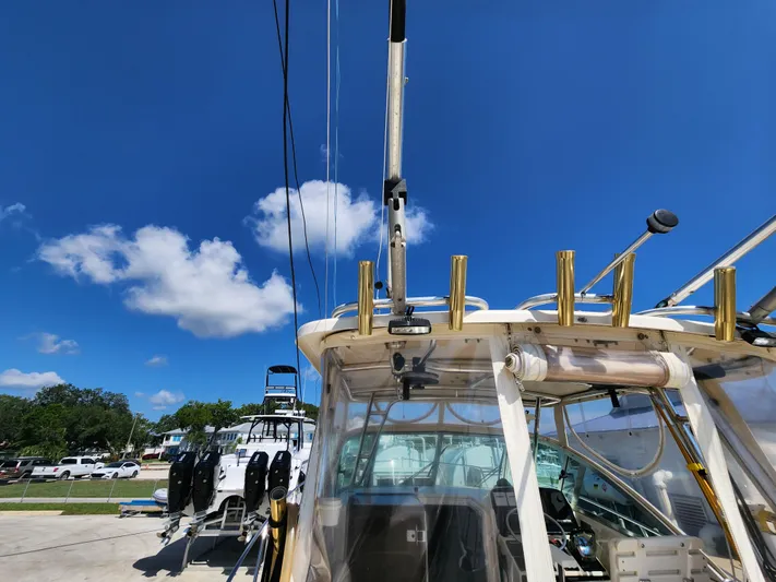 N' Pursuit Yacht Photos Pics 2005 Pursuit 3070 Offshore Center Console boat under clear blue sky.
