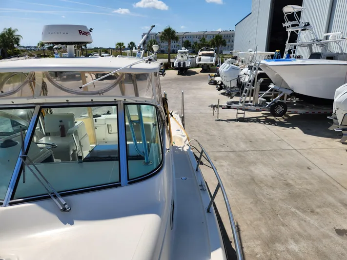 N' Pursuit Yacht Photos Pics 2005 Pursuit 3070 Offshore Center Console boat in a marina with other vessels.