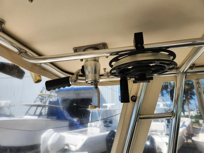 N' Pursuit Yacht Photos Pics 2005 Pursuit 3070 Offshore Center Console interior with fishing rod holder and reel.