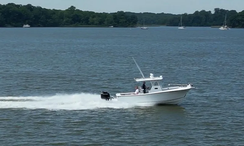  Yacht Photos Pics Custom 2017 Carolina Style boat cruising on a lake with forested shoreline.