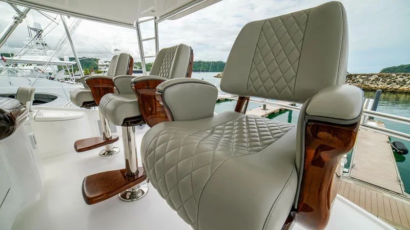 Free Spool Yacht Photos Pics Luxurious seating on 2023 Viking 72 yacht, featuring elegant quilted upholstery and wooden accents.