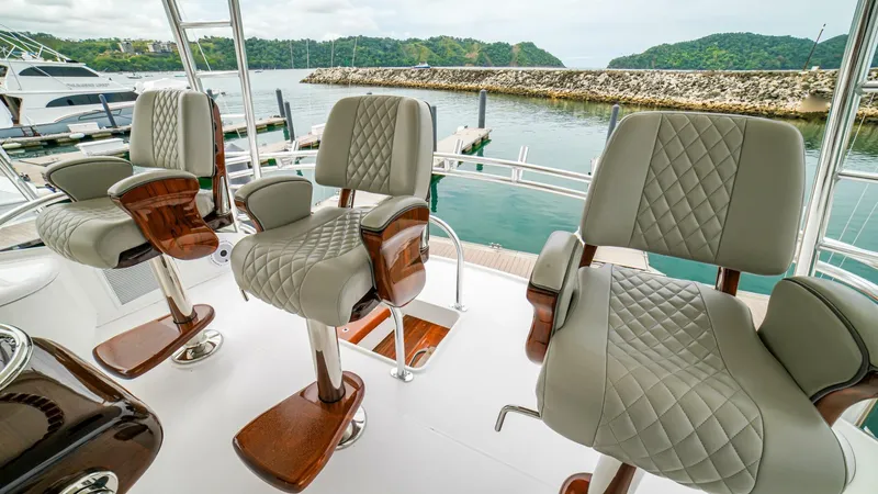 Free Spool Yacht Photos Pics Luxurious seating on 2023 Viking 72 yacht, featuring quilted leather and wooden accents.