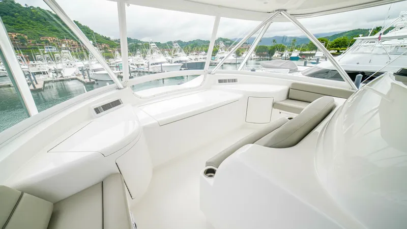 Free Spool Yacht Photos Pics Luxurious 2023 Viking 72 yacht interior with sleek seating and marina view.