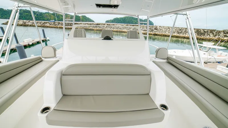 Free Spool Yacht Photos Pics 2023 Viking 72 yacht interior with luxurious seating and scenic marina view.