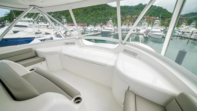 Free Spool Yacht Photos Pics Luxurious 2023 Viking 72 yacht interior with marina view.
