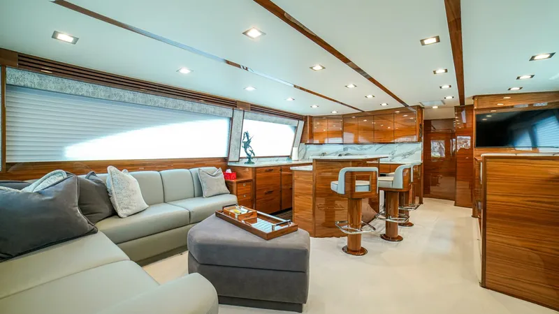 Free Spool Yacht Photos Pics Luxurious interior of 2023 Viking 72 yacht with modern seating and elegant wood finishes.