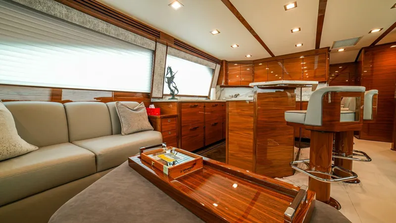 Free Spool Yacht Photos Pics Luxurious interior of 2023 Viking 72 yacht with elegant wood finishes and modern seating.
