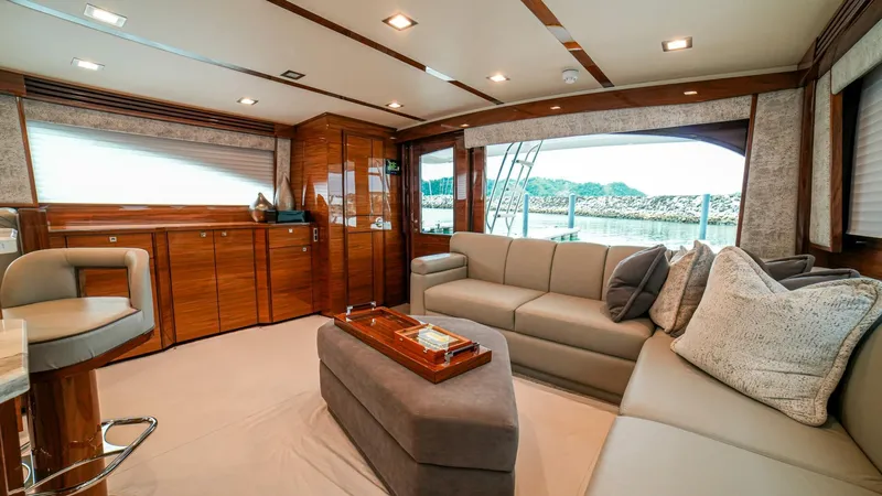 Free Spool Yacht Photos Pics Luxurious interior of 2023 Viking 72 yacht with elegant seating and wooden finishes.