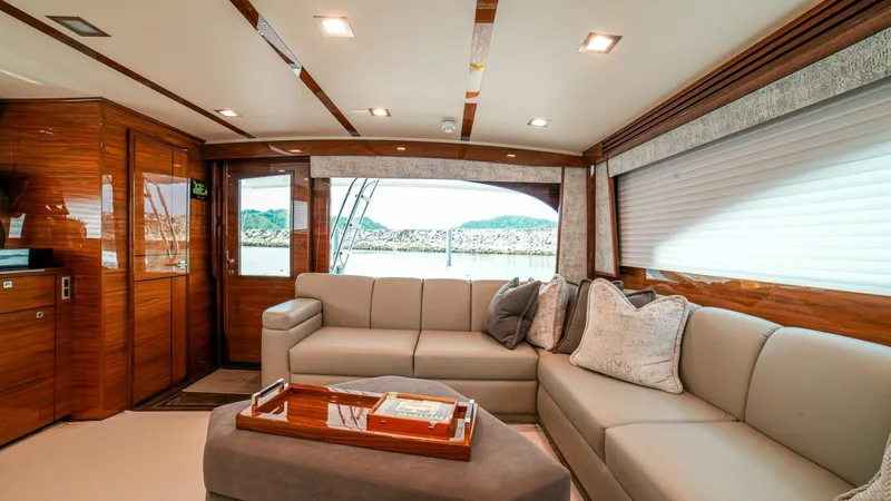 Free Spool Yacht Photos Pics Luxurious interior of 2023 Viking 72 yacht with elegant seating and wooden accents.