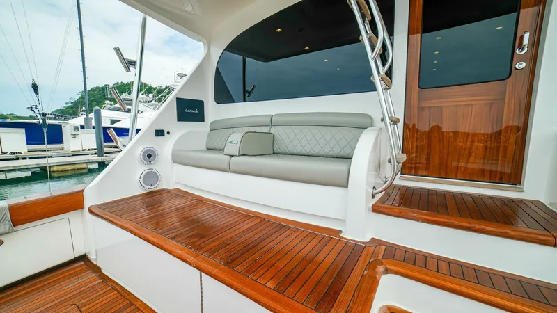 Free Spool Yacht Photos Pics Luxurious 2023 Viking 72 yacht with elegant teak deck and comfortable seating area.