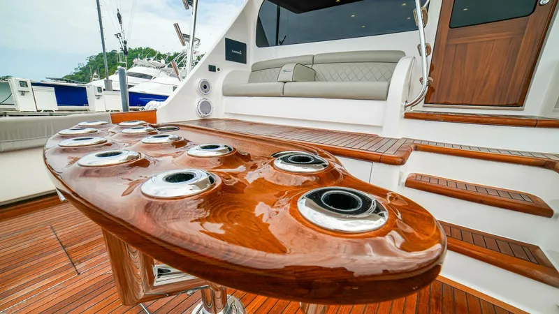 Free Spool Yacht Photos Pics Luxurious 2023 Viking 72 yacht deck with polished wood and seating area.