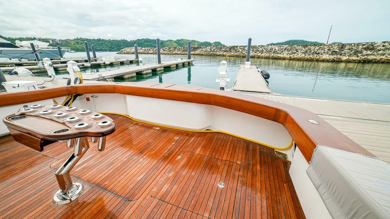 Free Spool Yacht Photos Pics Luxury Viking 72 yacht deck with wooden finish, docked at marina, 2023 model.