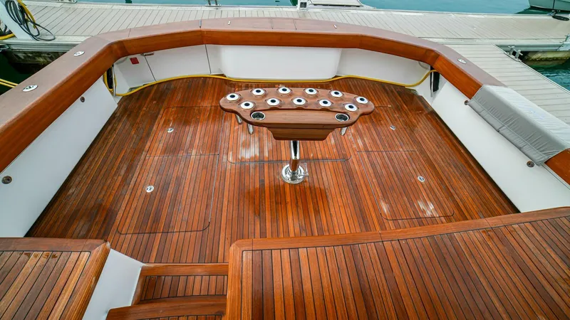 Free Spool Yacht Photos Pics Luxurious 2023 Viking 72 yacht deck with polished wood finish and central rod holder.