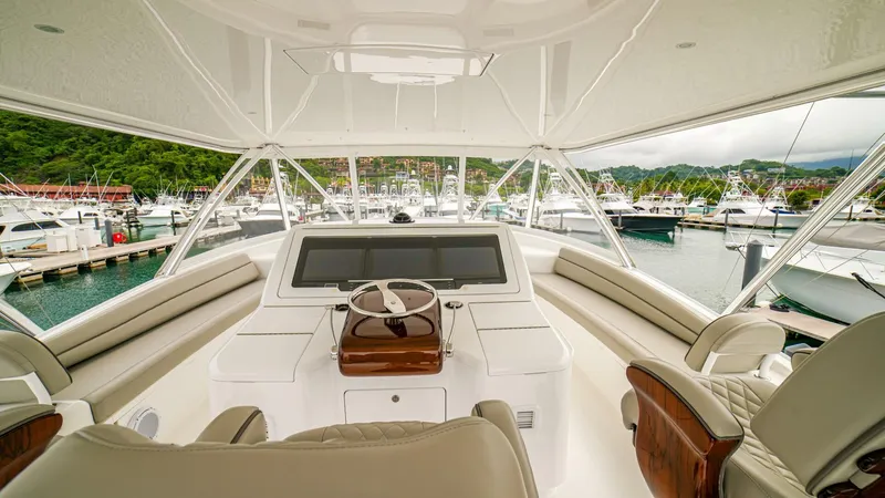 Free Spool Yacht Photos Pics Luxurious 2023 Viking 72 yacht helm with panoramic marina view.