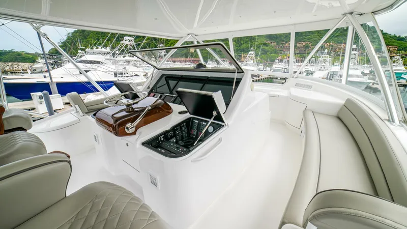 Free Spool Yacht Photos Pics Luxurious 2023 Viking 72 yacht cockpit with modern navigation equipment and plush seating.