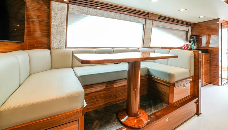 Free Spool Yacht Photos Pics Luxurious interior of 2023 Viking 72 yacht with elegant seating and wooden finishes.