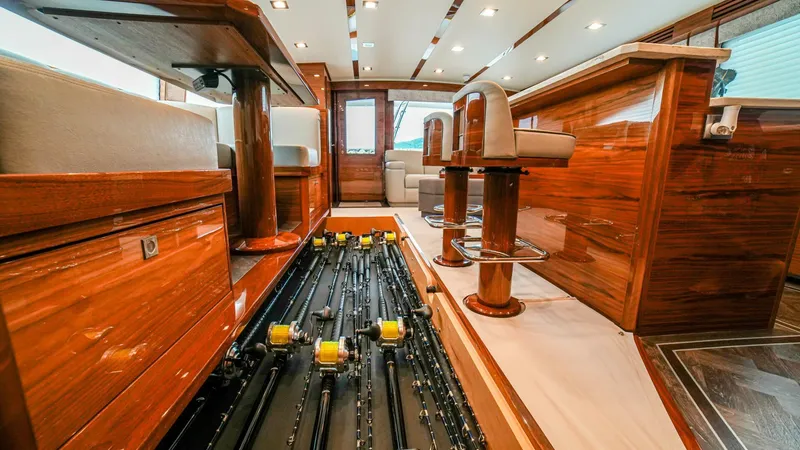 Free Spool Yacht Photos Pics Luxurious 2023 Viking 72 yacht interior with wooden finishes and fishing rod storage.