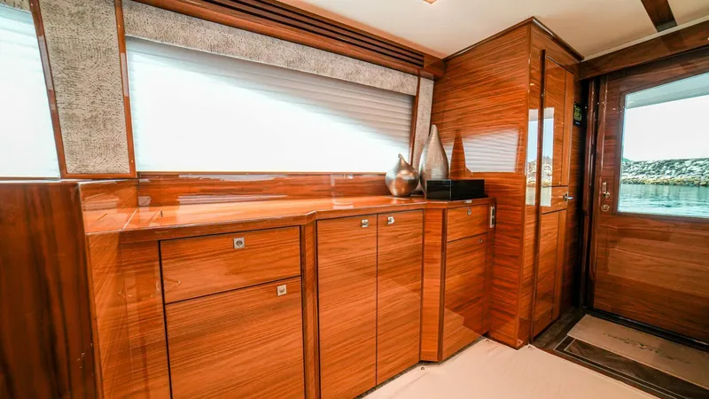 Free Spool Yacht Photos Pics Luxurious interior of 2023 Viking 72 yacht with polished wood cabinetry and modern decor.