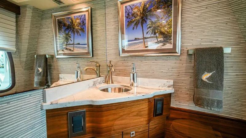 Free Spool Yacht Photos Pics Luxurious bathroom in 2023 Viking 72 yacht with marble sink and tropical decor.