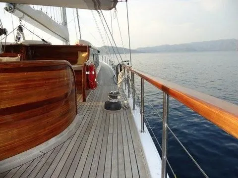  Yacht Photos Pics Luxurious 2006 Ketch 23.85 M yacht deck with wooden finish, sailing on calm waters.