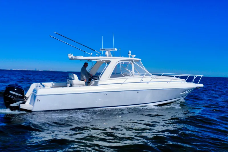  Yacht Photos Pics 2000 Intrepid 377 Walkaround boat cruising on open water under clear blue sky.