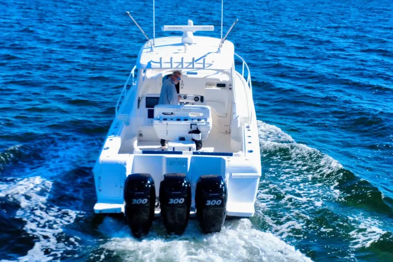  Yacht Photos Pics 2000 Intrepid 377 Walkaround boat cruising on open water with triple engines.