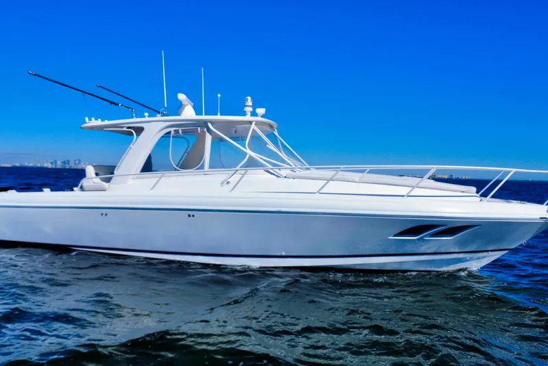  Yacht Photos Pics 2000 Intrepid 377 Walkaround boat cruising on open water under clear blue sky.